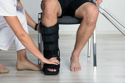 Adult wearing ankle support during recovery after ankle surgery