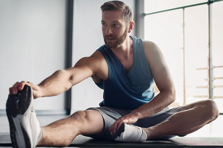 Adult performing ankle flexibility and mobility exercises