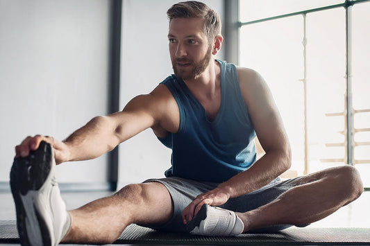 Adult performing ankle flexibility and mobility exercises
