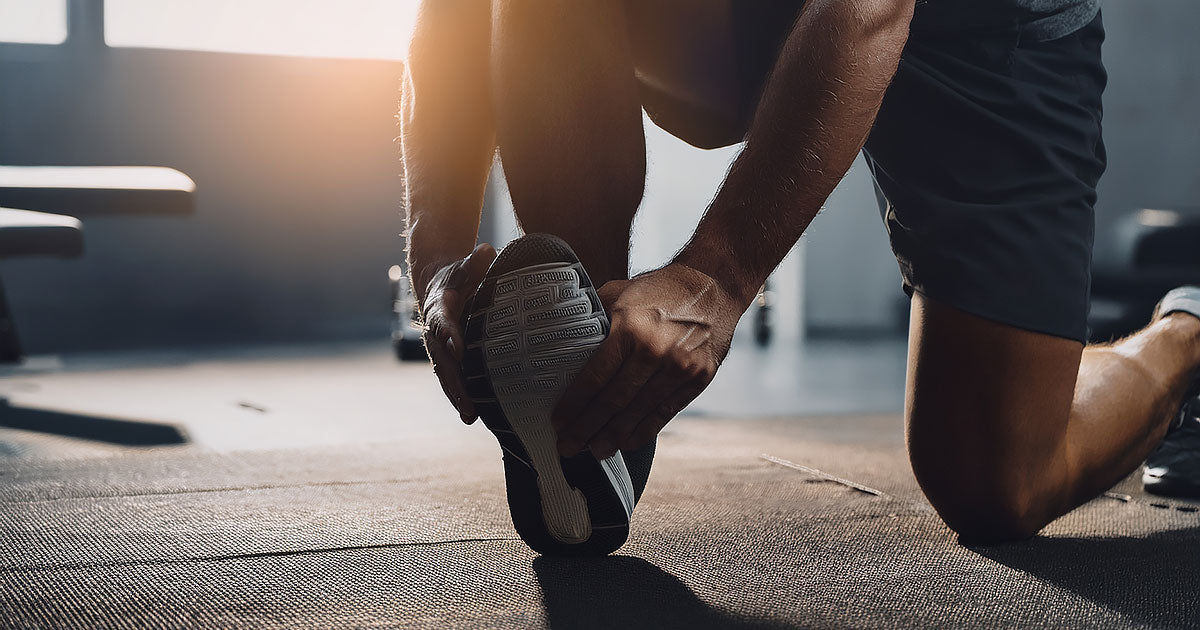 Young adult performing ankle exercises at home to improve weak ankle stability