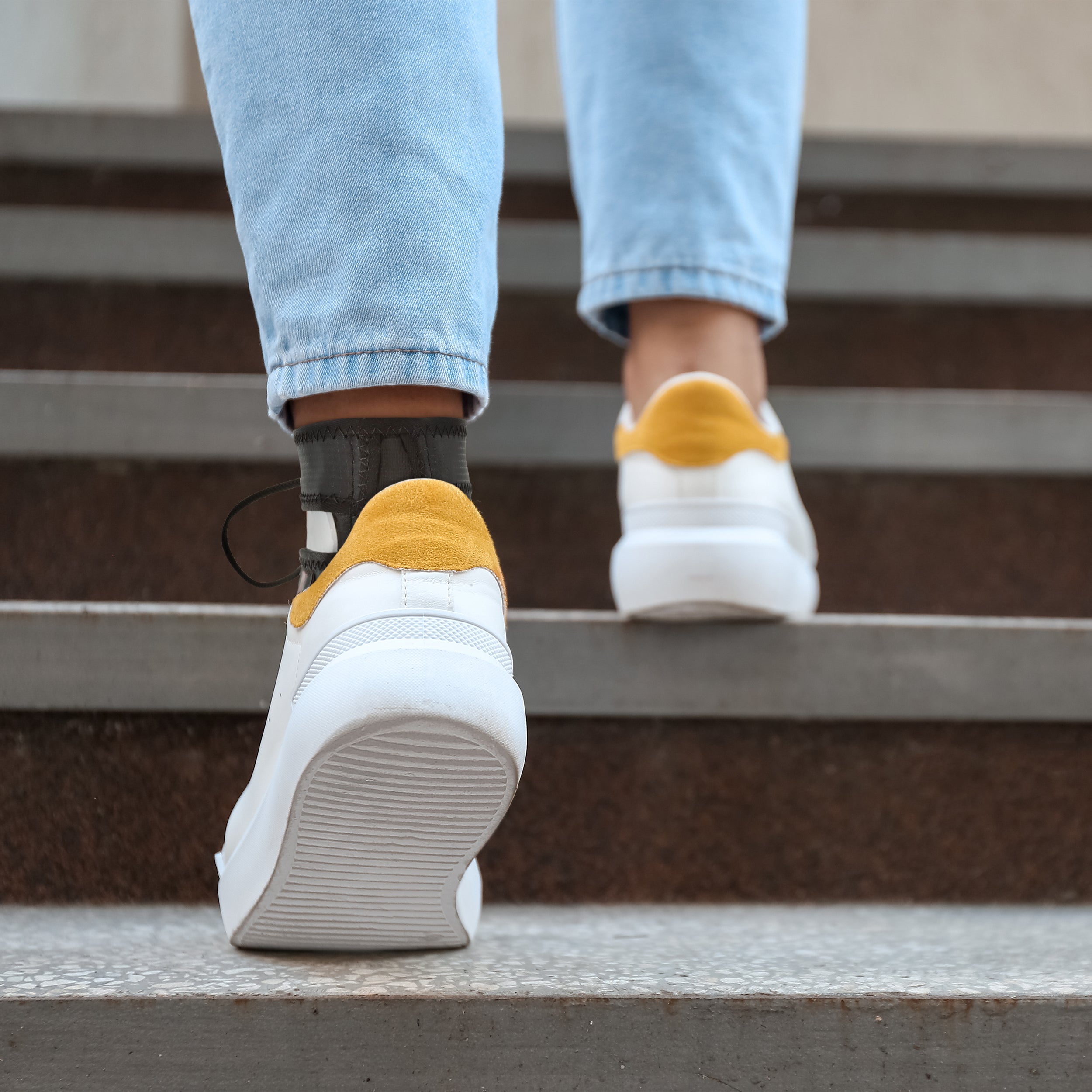 Swede-O Ankle Loc ankle brace worn on stairs for recovery support
